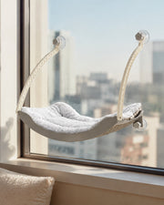 Curved Suction-Cup Window Hammock — Light Gray in a warm neutral home setting