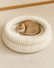 Cat using the ribbed plush bolster bed — cream large